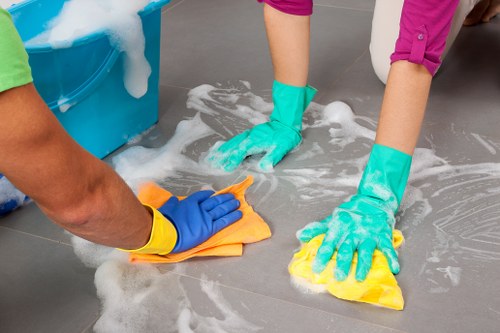 After builders cleaning team removing dust from a renovated room