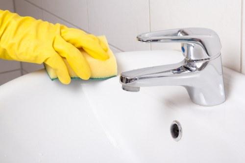 Professional cleaner disinfecting high-touch communal surfaces